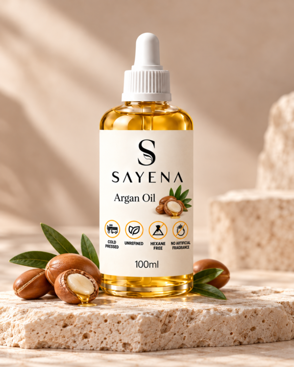 SAYENA Argan Oil 100ml bottle with botanical ingredients on an ivory stone display