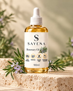 SAYENA Rosemary Oil 100ml bottle with rosemary sprigs on an ivory stone display